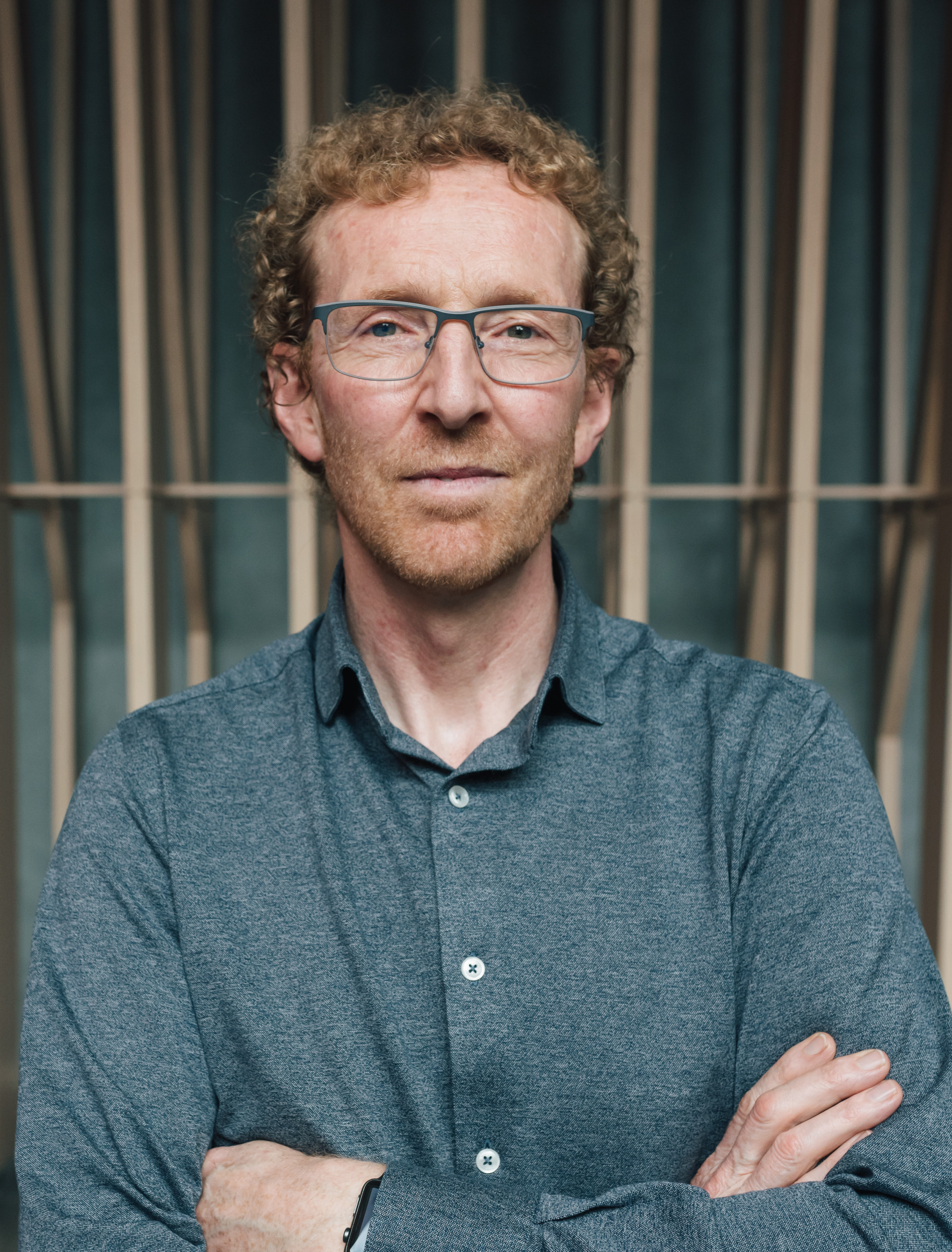 A large photo of Alan with his arms crossed.